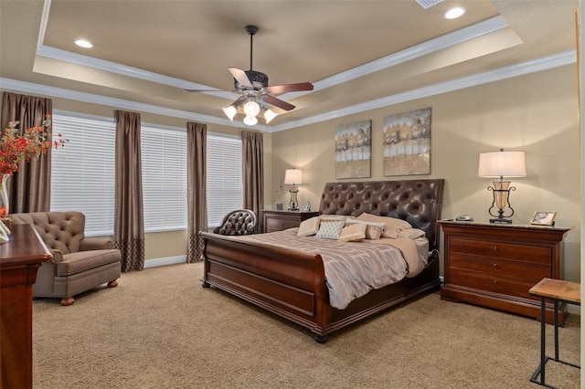 bedroom with a raised ceiling, ceiling fan, light colored carpet, and ornamental molding