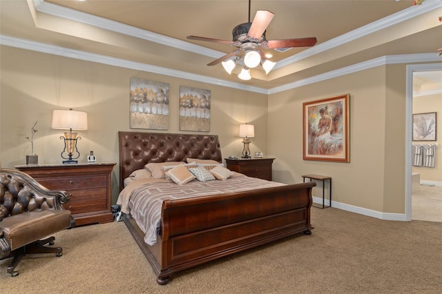 carpeted bedroom featuring ceiling fan, ornamental molding, and a tray ceiling