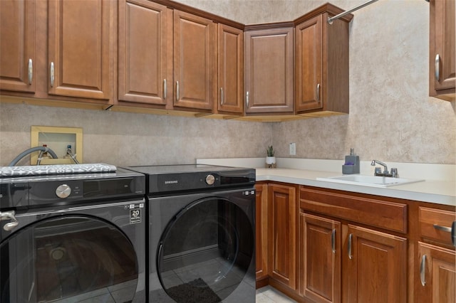 laundry area featuring separate washer and dryer, sink, and light tile patterned floors