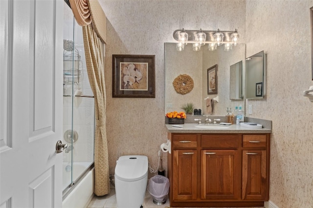 full bathroom featuring combined bath / shower with glass door, tile patterned floors, vanity, and toilet