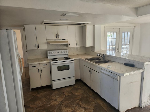 kitchen with french doors, sink, kitchen peninsula, white appliances, and white cabinets