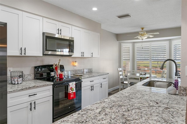 kitchen featuring black appliances, white cabinets, sink, ceiling fan, and a textured ceiling