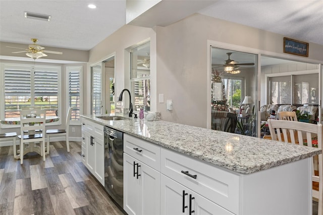 kitchen with white cabinets, a textured ceiling, dark wood-type flooring, sink, and dishwasher