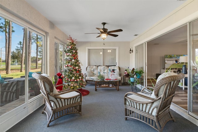 sunroom featuring ceiling fan