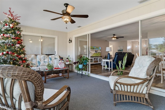 living room with ceiling fan, dark hardwood / wood-style floors, and a wealth of natural light