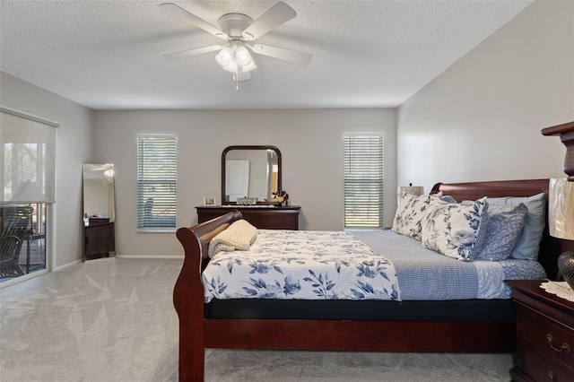 carpeted bedroom with a textured ceiling and ceiling fan