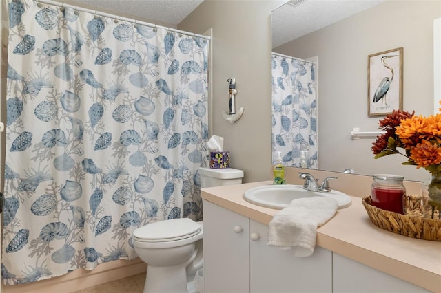 bathroom with vanity, tile patterned floors, toilet, a textured ceiling, and walk in shower