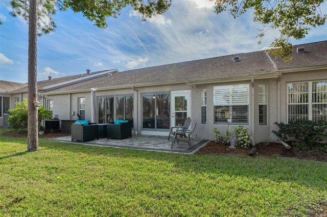 rear view of house featuring a lawn and a patio area