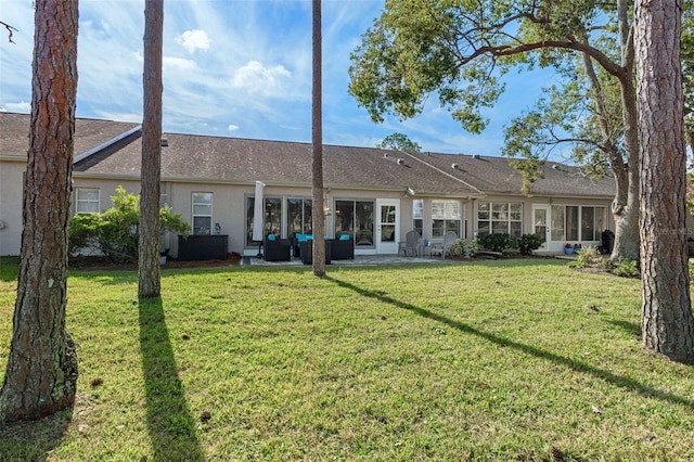 rear view of property with a yard, a patio, and an outdoor hangout area