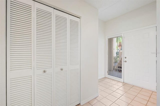 foyer entrance with light tile patterned floors