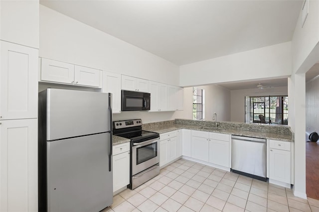 kitchen featuring a wealth of natural light, white cabinetry, sink, and stainless steel appliances