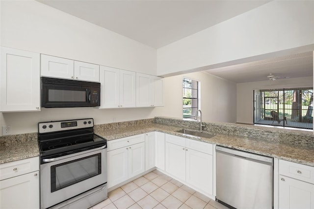 kitchen featuring white cabinets, stainless steel appliances, light tile patterned flooring, and sink