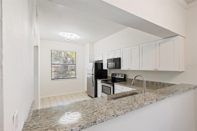 kitchen featuring light stone countertops, appliances with stainless steel finishes, sink, light tile patterned floors, and white cabinetry