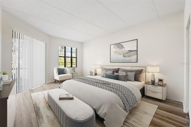 bedroom featuring a textured ceiling and light wood-type flooring