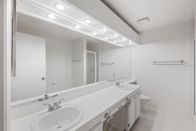 bathroom featuring an enclosed shower, vanity, toilet, and tile patterned floors