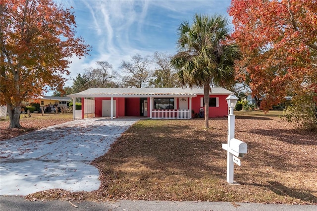 single story home with a carport and covered porch