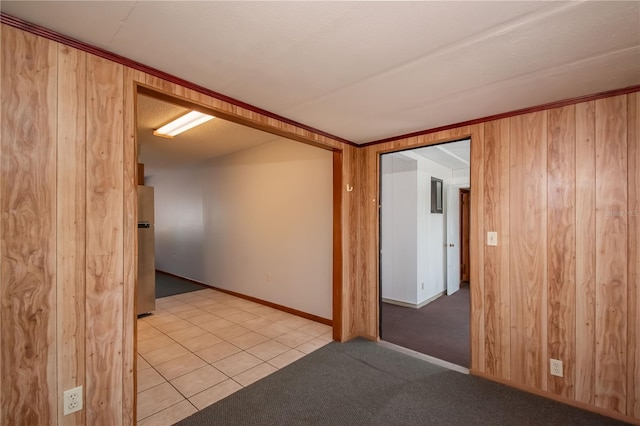 tiled spare room featuring a textured ceiling and wooden walls