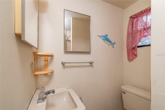 bathroom with sink and toilet