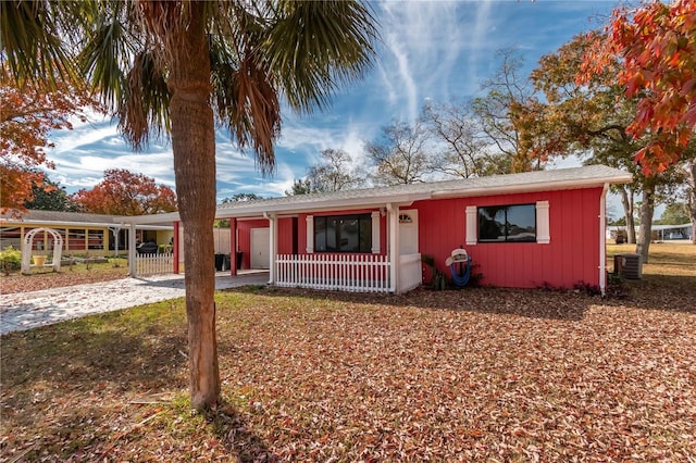 ranch-style house with central AC and a carport