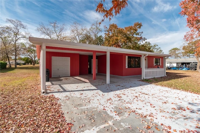 garage featuring a lawn and a carport