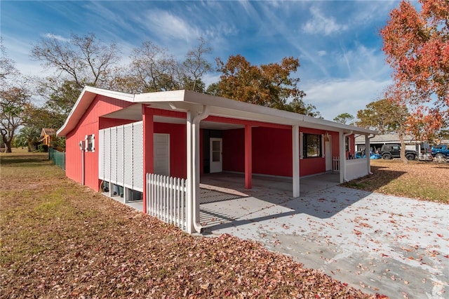 view of side of property with a carport