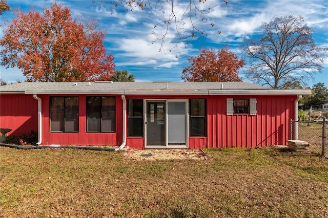 back of house with a lawn