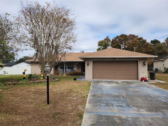 ranch-style house featuring a front yard and a garage