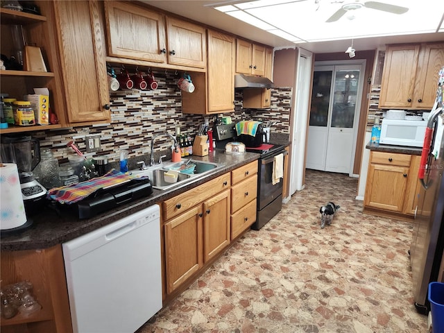 kitchen with tasteful backsplash, ceiling fan, sink, and white appliances