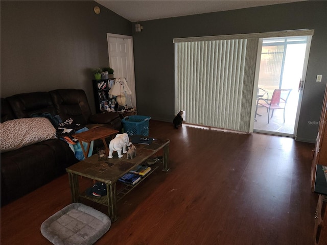 living room featuring dark hardwood / wood-style floors and lofted ceiling