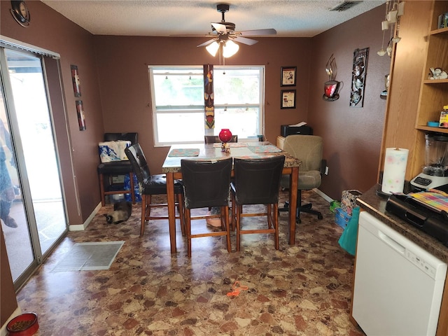 dining space featuring a textured ceiling and ceiling fan