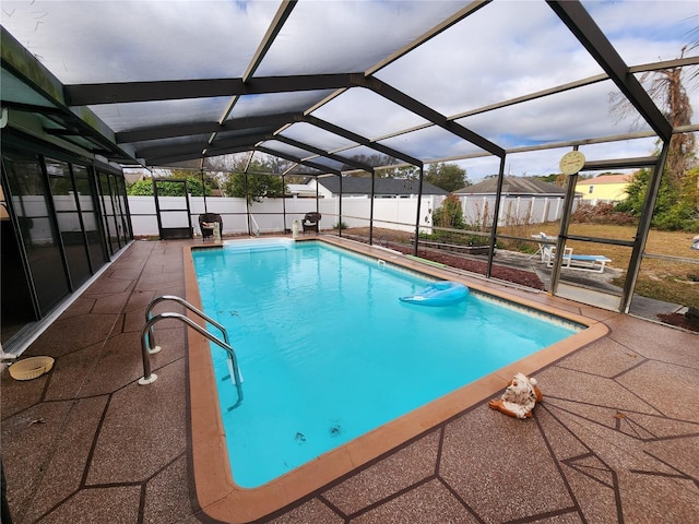 view of swimming pool with a lanai and a patio area