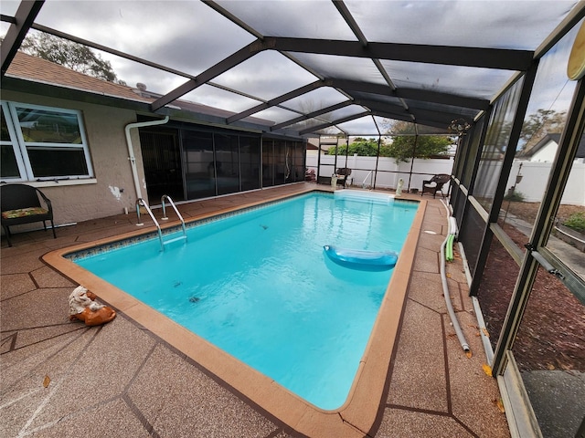 view of pool with a lanai and a patio