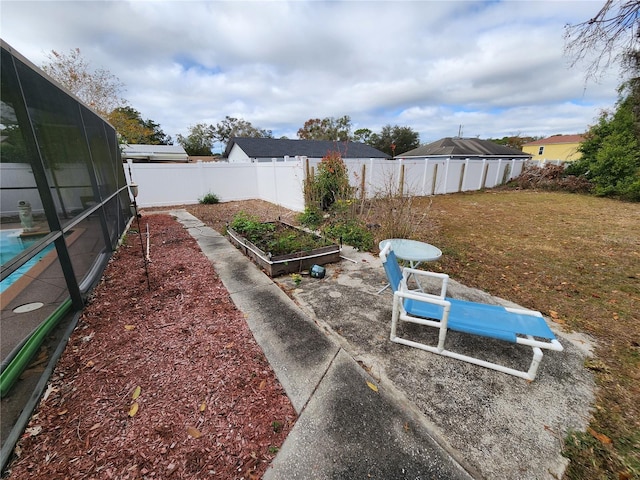 view of yard featuring a garden and a fenced backyard