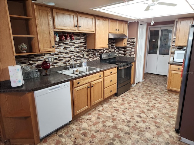 kitchen with white appliances, dark countertops, under cabinet range hood, open shelves, and a sink