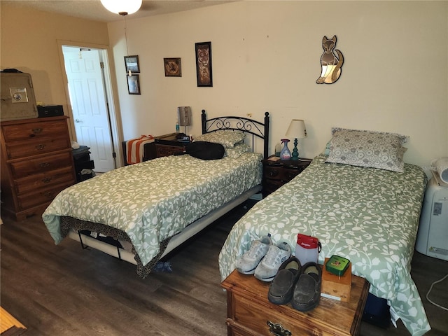 bedroom featuring dark wood-style flooring