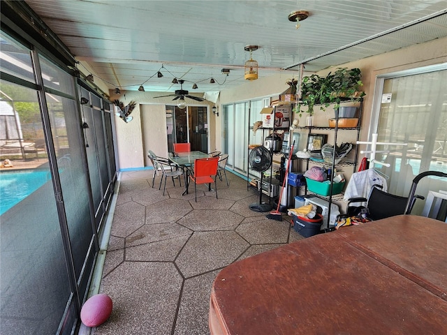 sunroom with plenty of natural light and ceiling fan