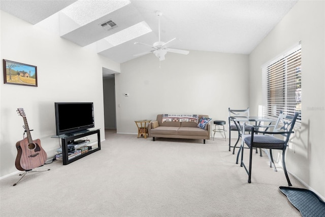 living room featuring carpet flooring, ceiling fan, and lofted ceiling