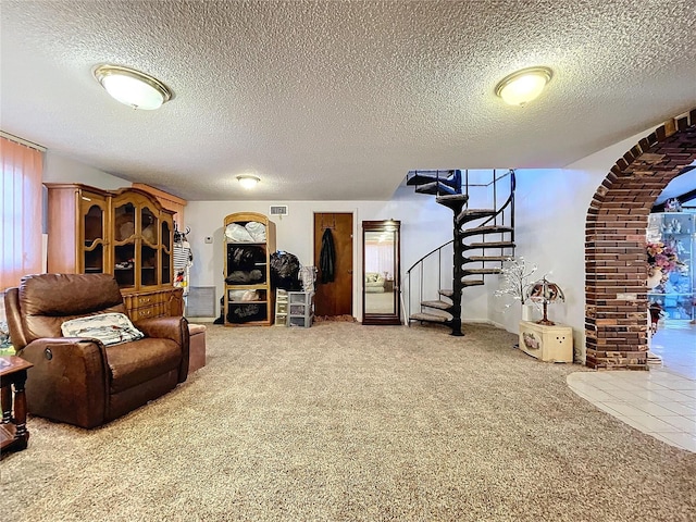 carpeted living room with a textured ceiling