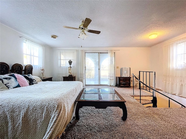 carpeted bedroom with ceiling fan, crown molding, and a textured ceiling