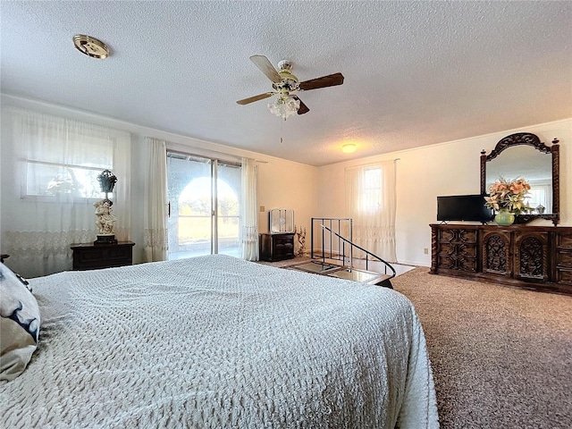 carpeted bedroom with ceiling fan, access to exterior, and a textured ceiling