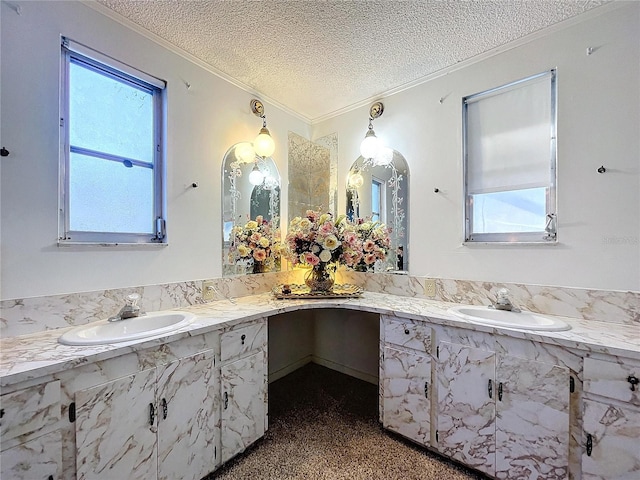 bathroom featuring vanity, a textured ceiling, and ornamental molding