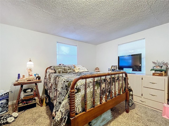 bedroom featuring light carpet and a textured ceiling