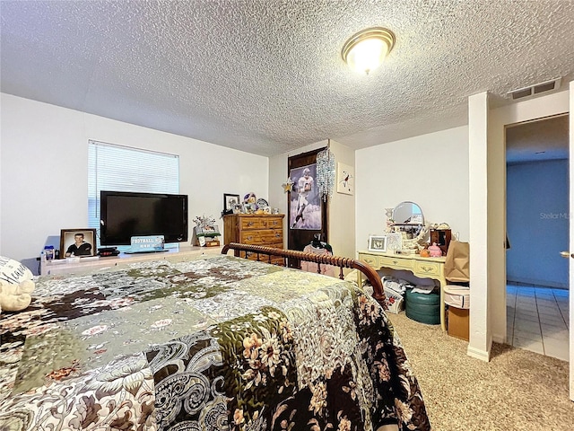 bedroom with carpet and a textured ceiling