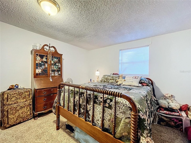 bedroom featuring carpet flooring and a textured ceiling