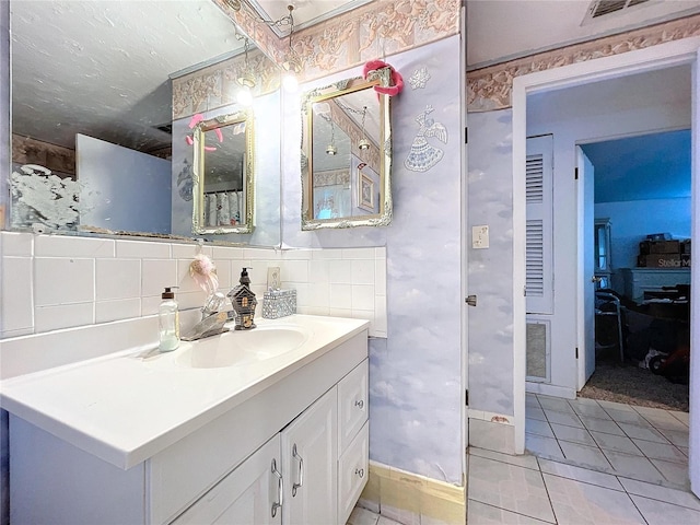 bathroom with tile patterned floors, vanity, and decorative backsplash