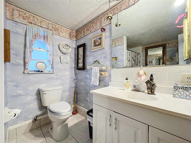 bathroom featuring vanity, tile patterned floors, toilet, a textured ceiling, and curtained shower