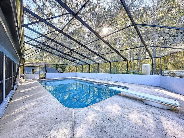 view of pool featuring a lanai, a diving board, and a patio area