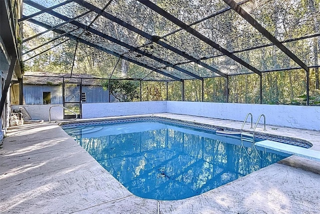 view of pool featuring a patio, a diving board, and a lanai