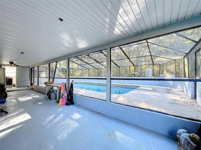 view of pool featuring a patio area, ceiling fan, and a lanai