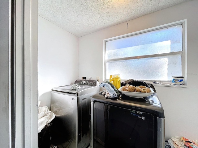 washroom featuring independent washer and dryer and a textured ceiling